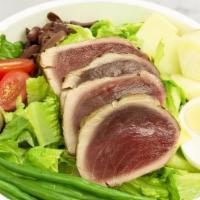 Seared Tuna Niçoise · Romaine, haricots verts, potatoes, anchovies, black olives, and hard-boiled egg with lemon d...
