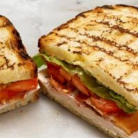 Turkey Club · Herb-Roasted Turkey Club, Tomato, Romaine, Crisp Smoked Bacon and Tarragon Dijonaise on a gr...