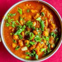 Chana Masala · Chick peas cooked with onions, tomatoes, and Indian spices.