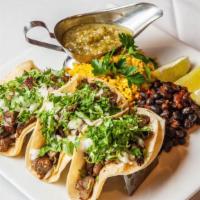 Steak Tacos · Three stuffed soft corn tortillas served with yellow rice ,black beans and spicy sauce