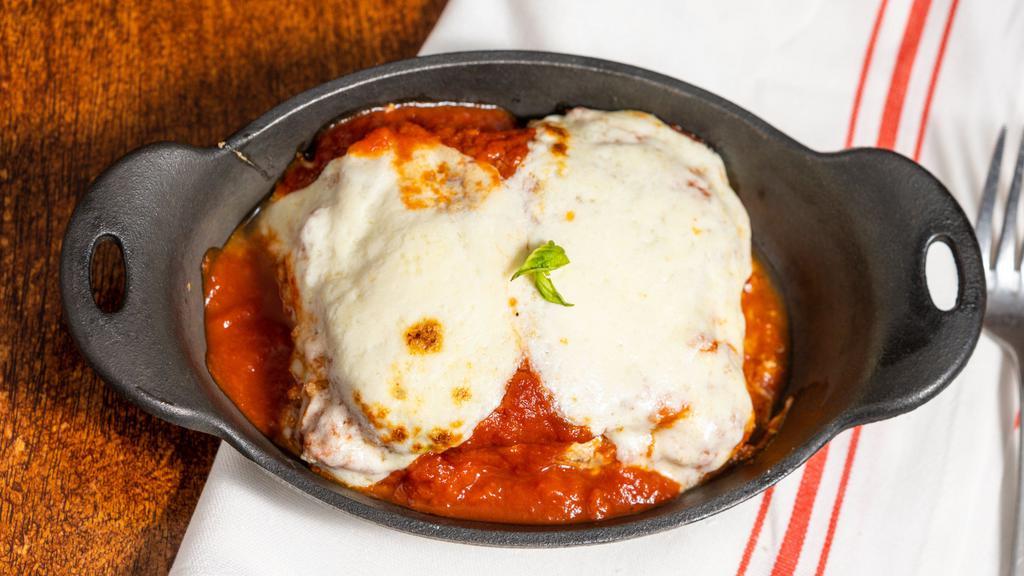 Lasagna All'Napoletana · Homemade pasta layered with meat and cheese and baked in tomato sauce.