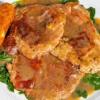 Saltimbocca Alla Romano · Veal topped with prosciutto in a butter-sage sauce. Served with a potato croquette and the c...