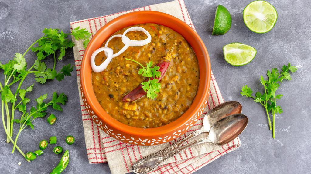 Dal Makhani · Black lentils and kidney beans with herbs and spices boiled to perfection.