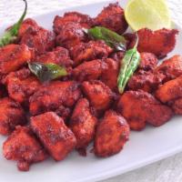 Chicken 65 · Cubes of chicken cooked in spicy red sauce with whole red chillies and curry leaves.