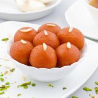 Gulab Jamun · A light pastry dumpling made from dry milk and honey.