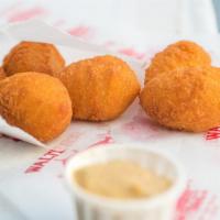 Potato Puffs · Buttery, mashed potato bites with a crispy outer shell.