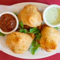 Vegetable Samosa · Two pieces. Spiced potatoes, green pea filling.