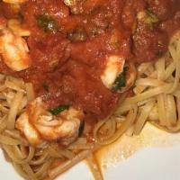 Shrimp Marinara · Shrimp sautéed in garlic and oil topped with marinara on a bed of linguine. Served with choi...