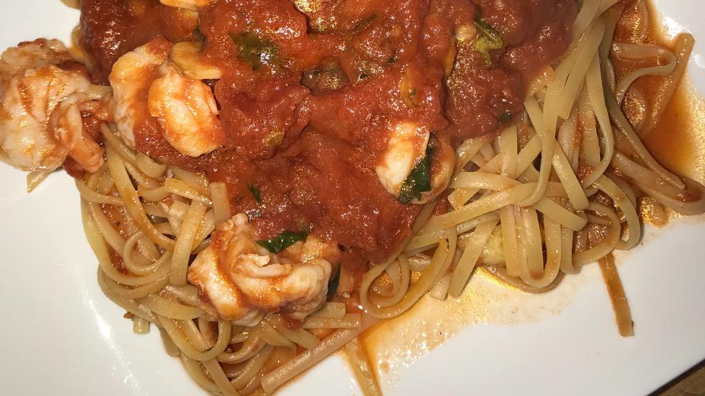 Shrimp Marinara · Shrimp sautéed in garlic and oil topped with marinara on a bed of linguine. Served with choice of side.