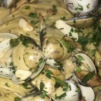 Linguine With Clam Sauce · Whole baby clams sautéed with fresh garlic and oil with choice of sauce. Served with fresh b...