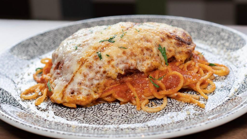 Chicken Parmigiana · Breaded cutlet of chicken, marinara, and mozzarella over spaghetti.