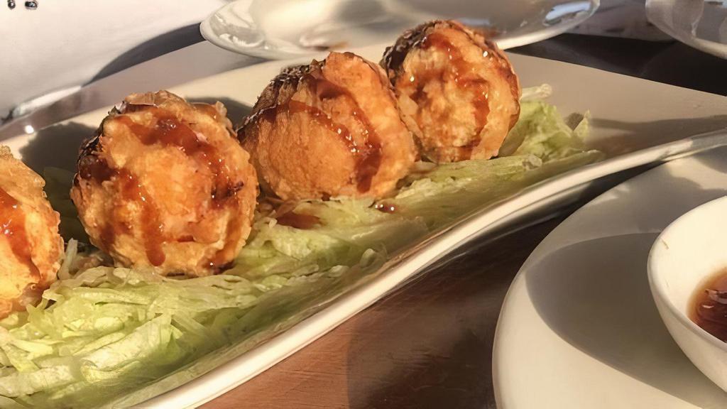 Monkey Balls · Scallions, crab meat, spicy tuna, massago, breaded and deep fried with sauce.