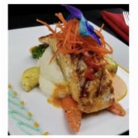 Dc Salmon · Grilled wild caught salmon served over Mashed Potatoes and mixed vegetables
