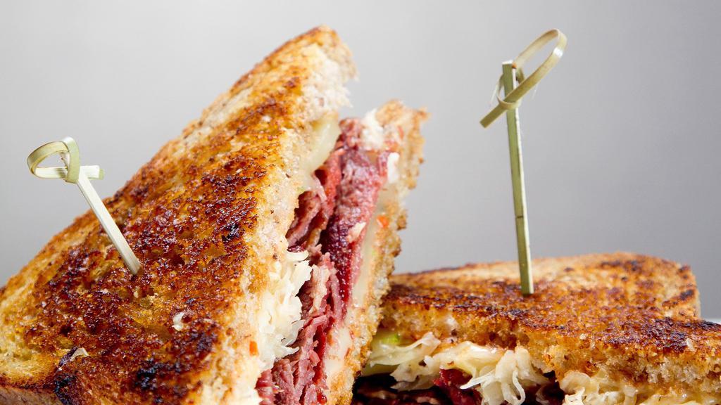 Grilled Reuben · Marbled Rye, thousand islands, sliced corned beef, sauerkraut, swiss cheese. With Fries.