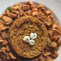 Doro Tibs With Jollof Rice · Rice cooked in flavorful tomato and pepper puree served with sautéed chicken, jalapeños and ...