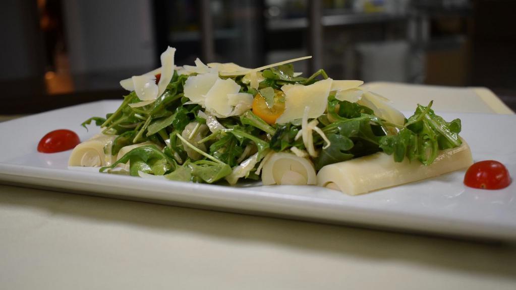 Heart Of Palm Salad · Hearts of Palm, shaved fennel, medley tomato, and arugula in citrus vinaigrette with shaved parmesan on top