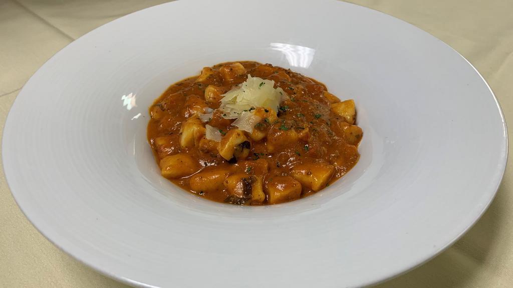 House Made Ricotta Gnocchi · Handmade ricotta gnocchi in our red bolognese meat sauce finished with mascarpone and shaved Parmesan cheese.