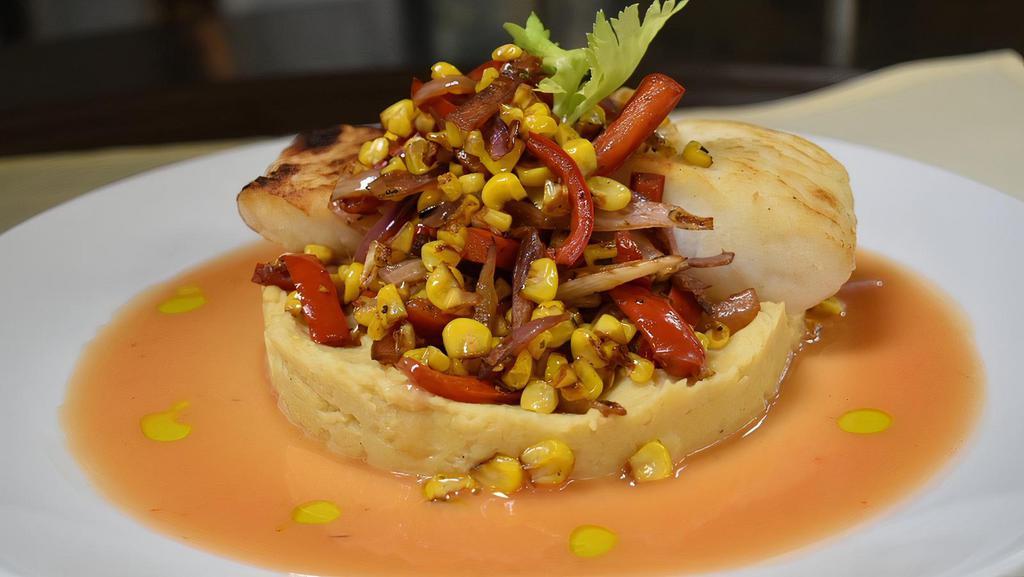 Pan Roasted Halibut · Served over a bed of cauliflower and chickpea puree, with roasted corn relish and finished with blood orange beurre blanc sauce