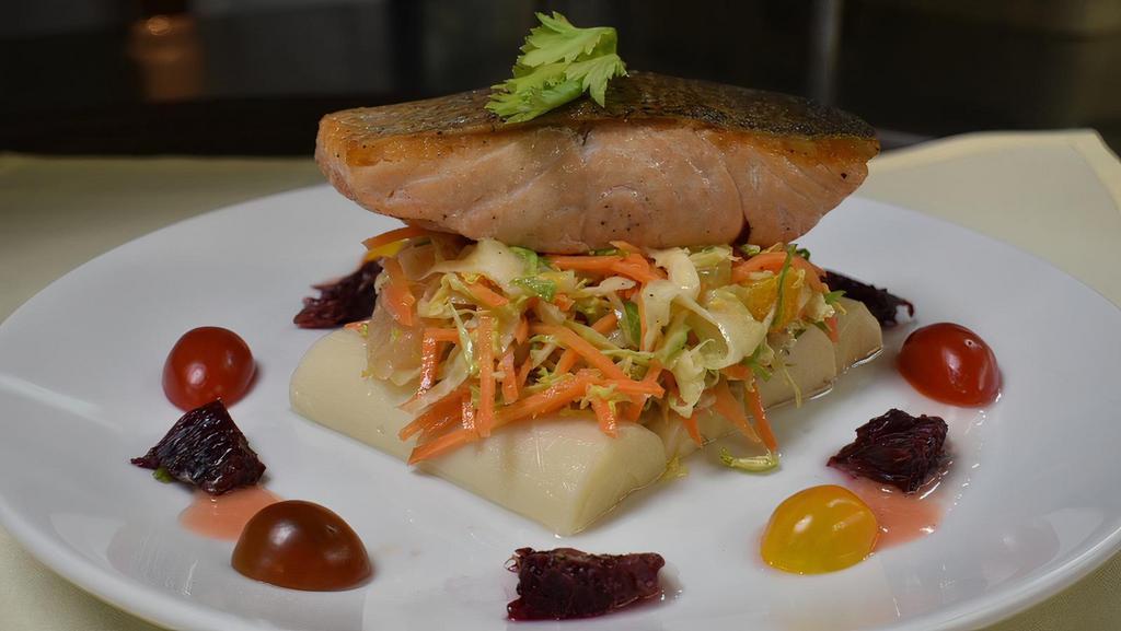 Pan Roasted Skin-On North Atlantic Salmon · Served with hearts of palm, citrus segment, shaved brussels sprouts, carrots, fennel, and topped with citrus vinaigrette and medley tomato