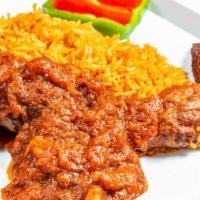Jollof Rice  · With choice of fried fish and goat stew or chicken stew