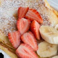 Pancake Platter · Three buttermilk pancakes with syrup and butter.