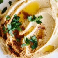 El Toum Appetizer · Our mix appetizer of hummus, baba ganoush, tabouli, falafel, and pita bread.