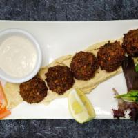 Falafel Plate · Deep fried chick peas and vegetables blended with spices served with hummus and tahini sauce...