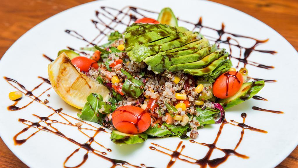 Quinoa Salad · Sliced avocado, corn, cucumber, red and green peppers, baby arugula and quinoa. Dressed with olive oil and balsamic dressing.