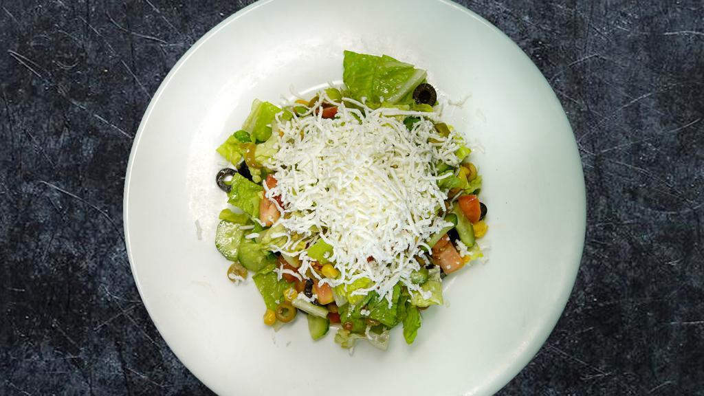 Mediterranean Salad · Chopped romaine lettuce, tomatoes, cucumbers, corn and olives. Topped with feta cheese and mixed with olive oil and lemon juice dressing.