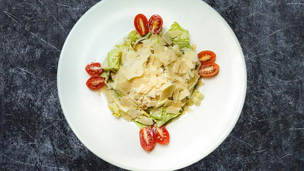 Caesar Salad · Chopped romaine lettuce in Caesar dressing topped with grated parmesan cheese and croutons.