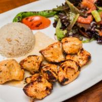 Chicken Shish Kebab · Marinated grilled chicken served with rice and mixed green salad.