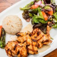 Chicken Chops · Marinated chicken thighs on the bone grilled to your taste. Served with rice and mixed green...