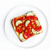 Chickpeas · Hummus spread on top with crispy chickpeas, roasted peppers, and crisp cucumbers.
