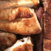 Chicken & Pork Ribs · Half BBQ chicken and half pork ribs, half pollo a la parrilla and half costillas de cerdo.