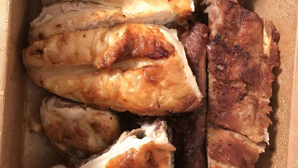 Chicken & Pork Ribs · Half BBQ chicken and half pork ribs, half pollo a la parrilla and half costillas de cerdo.
