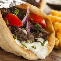 Beef Gyro · With beef gyro, lettuce, tomato, onion, and tzatziki sauce, served on pita bread.  Served wi...