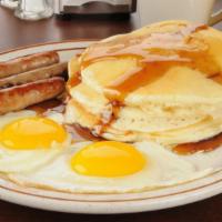 Pancakes With Two Eggs & Sausage · Delectable Pancakes with Two Sunny Eggs and Savory Sausage.