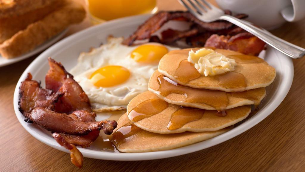 Pancakes With Two Eggs & Bacon · Delectable pancakes with two sunny eggs and crisoy bacon.