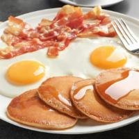 Pancakes With Two Eggs & Taylor Ham · Delectable pancakes with two sunny eggs and moist taylor ham.