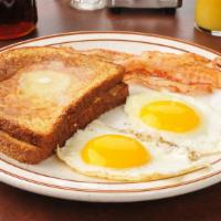 French Toast With Two Eggs & Sausage · Soft 'n' chewy French toast with two sunny eggs and savory sausage.
