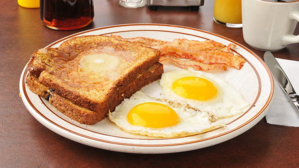 French Toast With Two Eggs & Sausage · Soft 'n' chewy French toast with two sunny eggs and savory sausage.