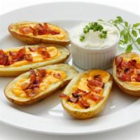Potato Skins With Bacon & Chedder Cheese · Plentiful skins with crispy bacon and chedder cheese.
