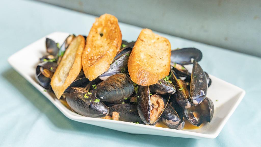 Chorizo White Wine Steamed Mussels · Fresh herbs and garlic bread, served with broth.