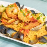 Seafood Paella · Fish, shrimp, mussels, clams, scallops, chorizo, saffron broth, and adobo rice.