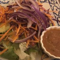 House Salad · A colorful assembly of lettuce, tomato, onion, cucumber, and carrot served with thai peanut ...