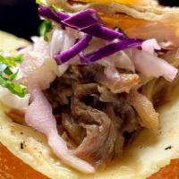 Cuba · Grilled slow-cooked pulled pork, citrus slaw, sliced orange, crispy onions and Chipotle Crema