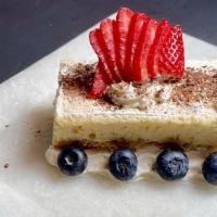 Tres Leches Cake · With strawberries and blueberries