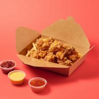 Medium Crunchy Bites Combo · 10 crispy chicken bites over tater tots or fries with 2 sauce.