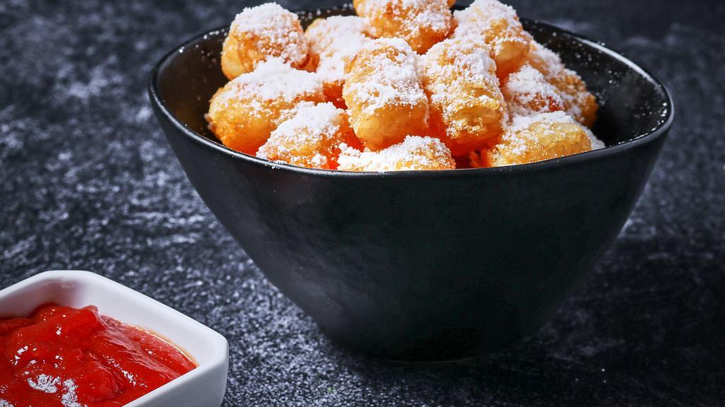 Parmesan Truffle Tots · Tater tots with fresh parmesan cheese and white truffle oil