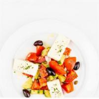 Horiatiki Salata · Salad of tomatoes, feta, cucumber, red onions, olives & oregano.
